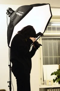 A photographer is shooting through umbrella 