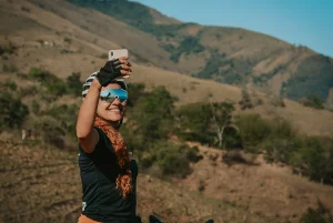 A image of a girl taking selfie by herself at a mountain