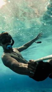 A Man is taking selfie while Snorkeling Underwater