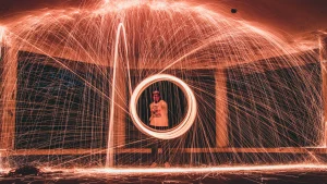 long exposure photo of A Man Holding a Sparkler