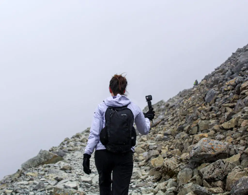 a woman hiking having a GoPro Karma Grip