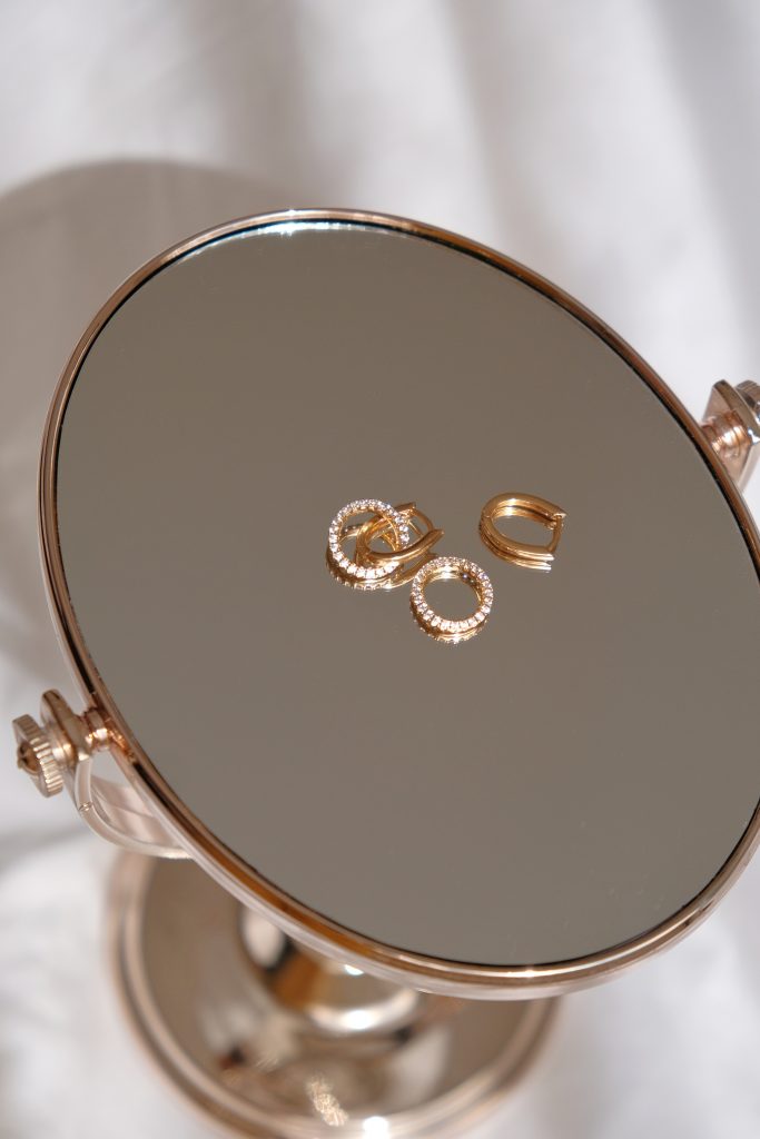A jewelry product on a mirror backdrop
