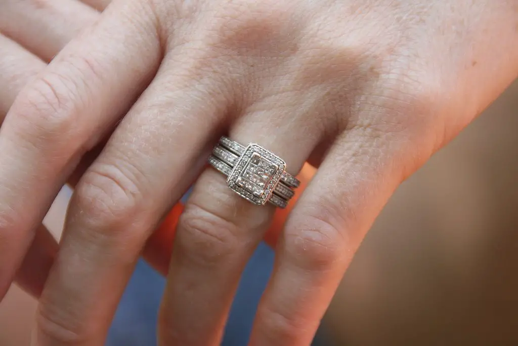A ring on the finger which looks less bright since the softbox is away from the ring 