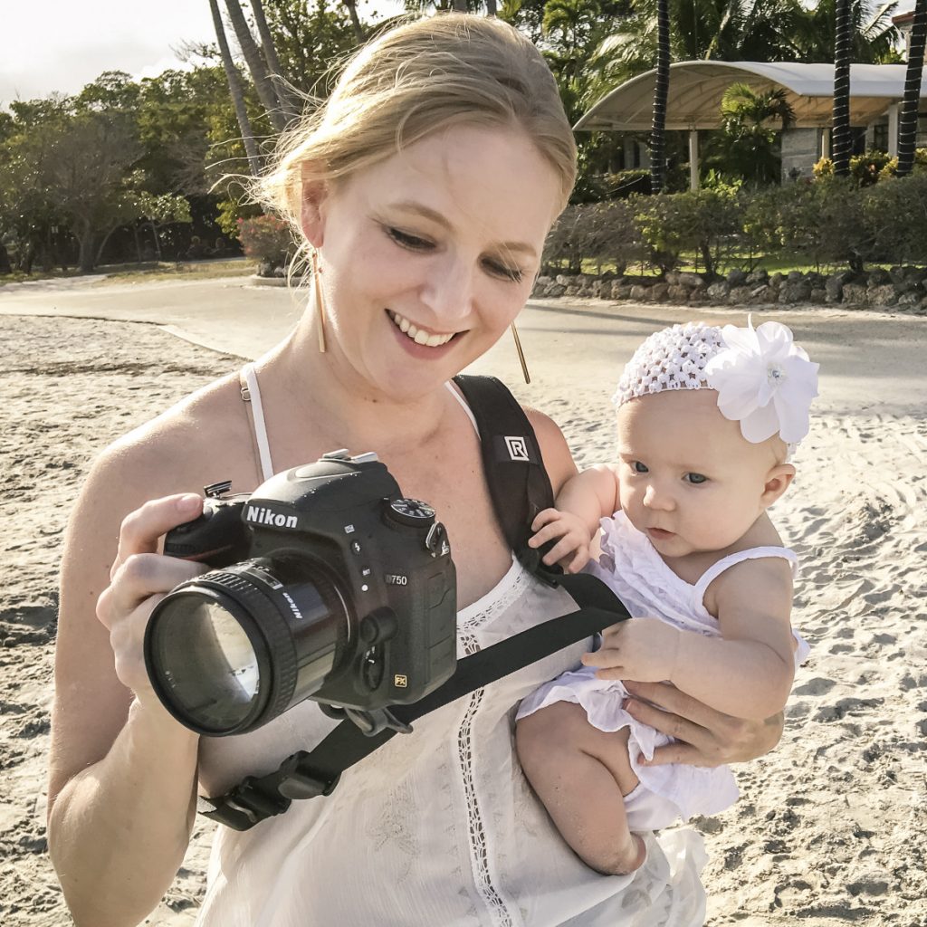 A mother using a camera with Blackrapid Curve Camera sling strap