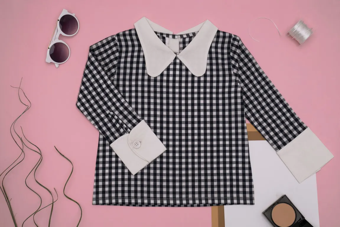 Flat lay photo of a Checkered Long Sleeves on a Pink Surface
