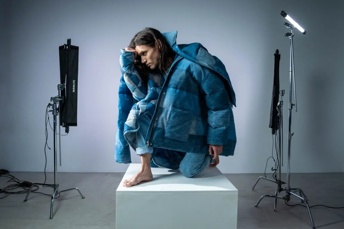 Man posing for a clothing photo inside a studio