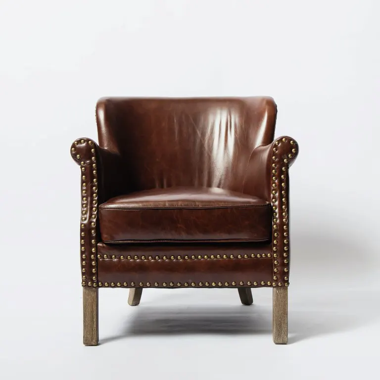 A brown leather chair on a white surface from the front view