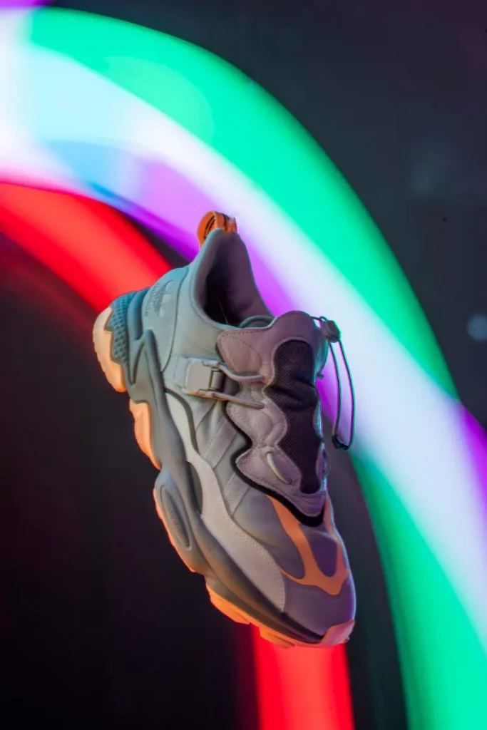 A floating Adidas footwear in the dramatic style product photo