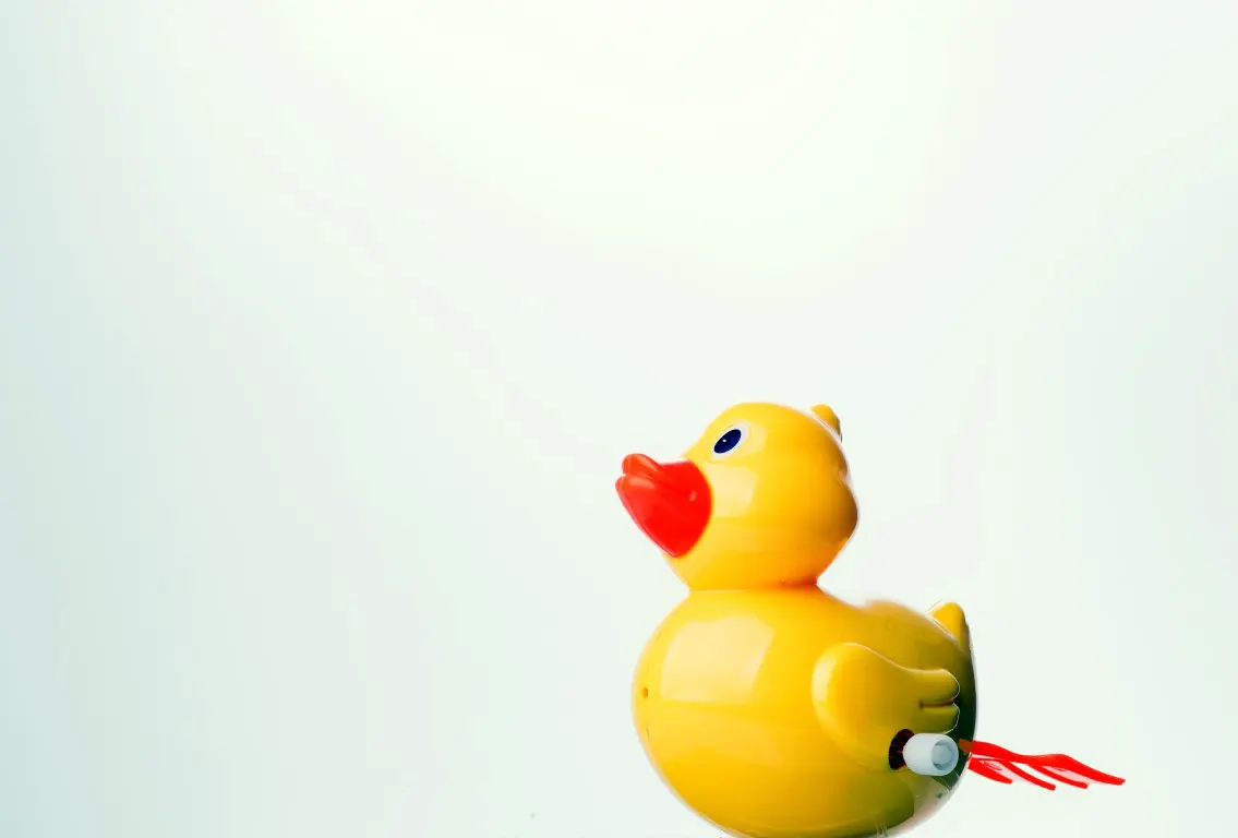 A yellow duck toy in the high-key Product photography style