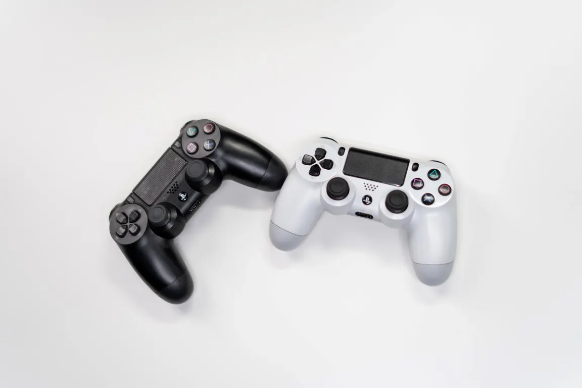 Minimalistic product photograph of white and black Sony Ps 4 game controller
