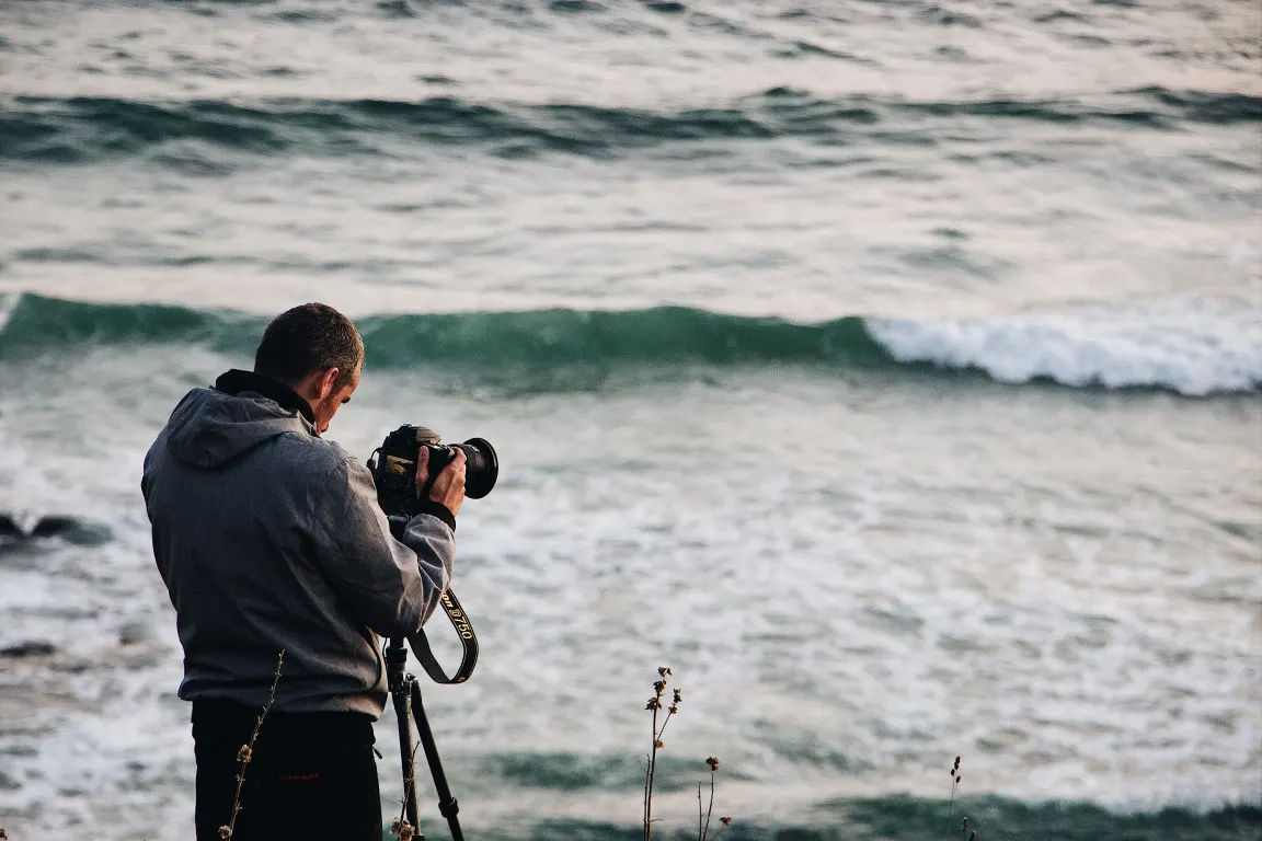 A man photographing from the beach
