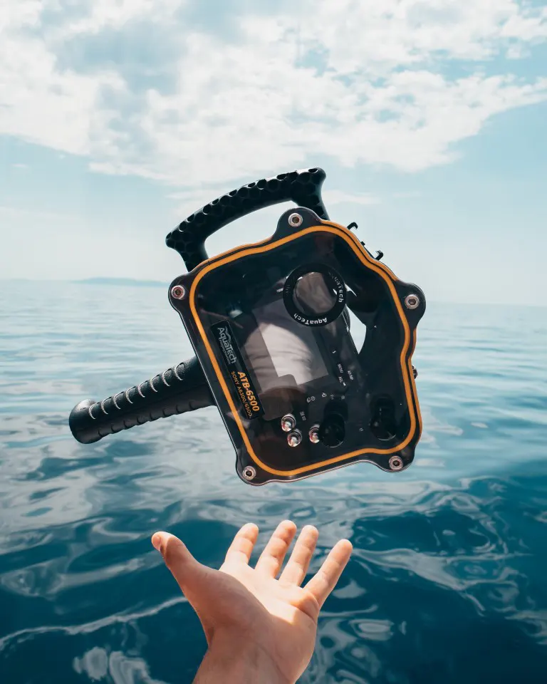 A camera water housing is hanging in the air