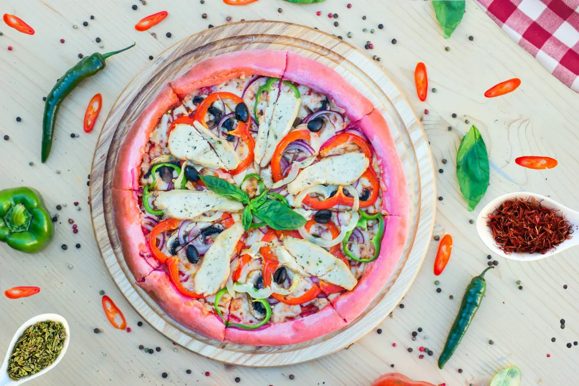 A flat lay food photo of a colorful sliced pizza