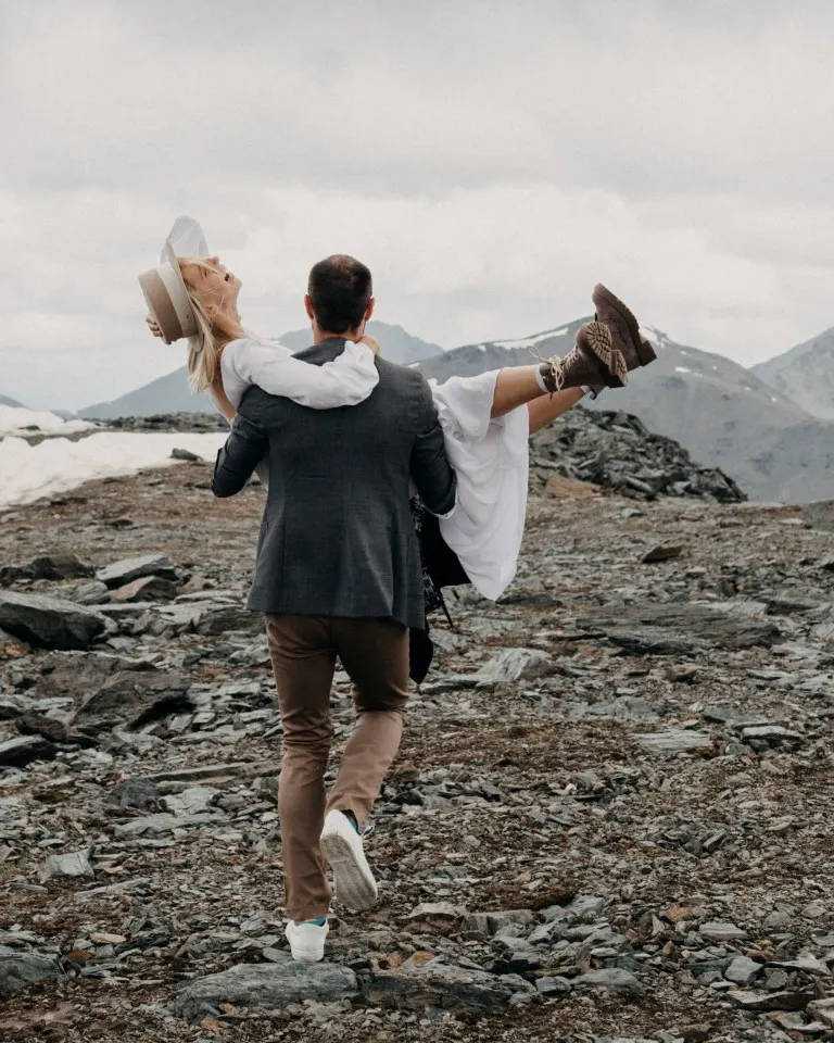 A groom carrying his bride on their elopement shoot
