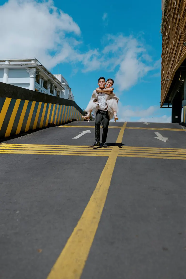 Elopement couple walking on asphalt road