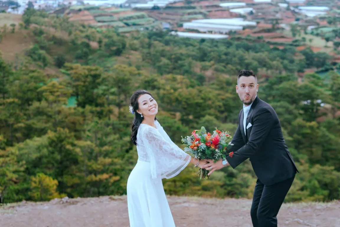 Funny elopement shot at the top of a mountain