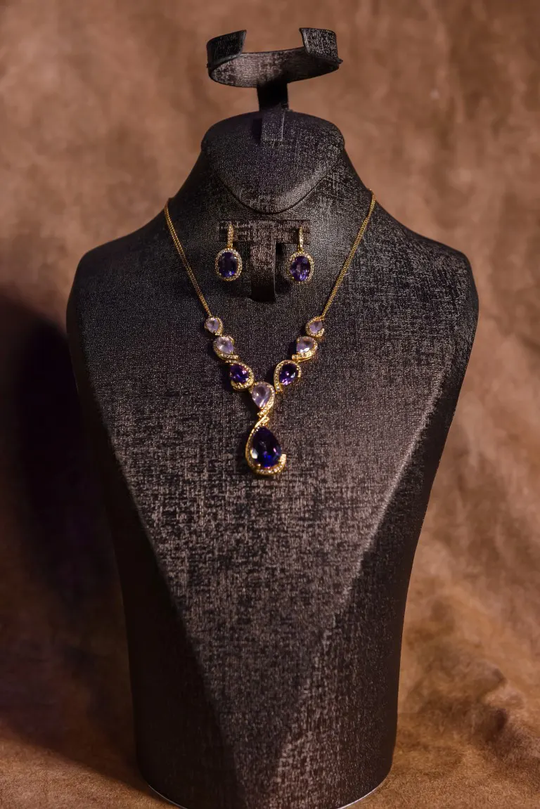 A set of jewelry on a mannequin stand