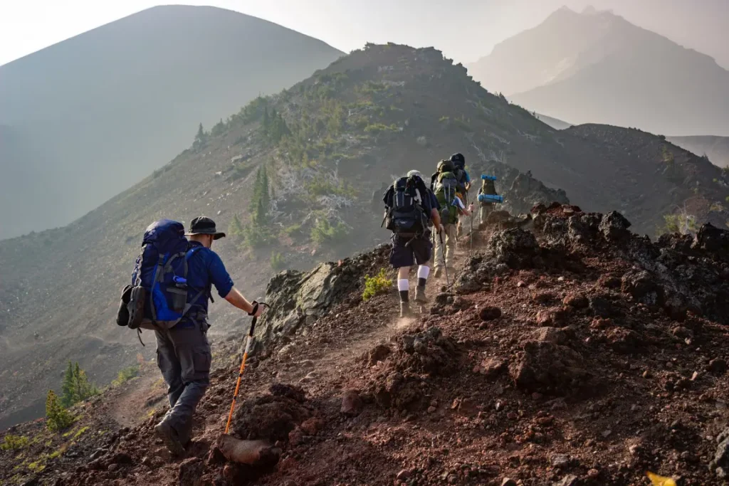 Group of backpackers walking on mountains