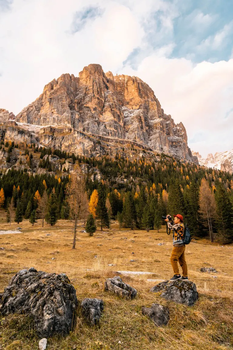 Man taking photos of a scenery on his hiking
