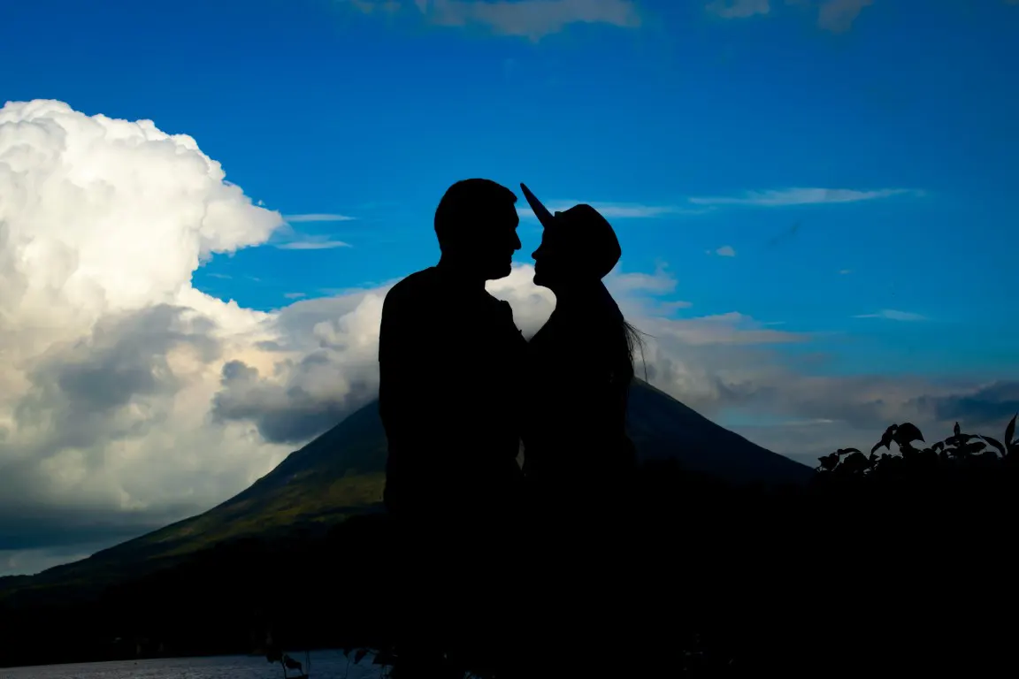Silhouette of Couple looking each other at hiking