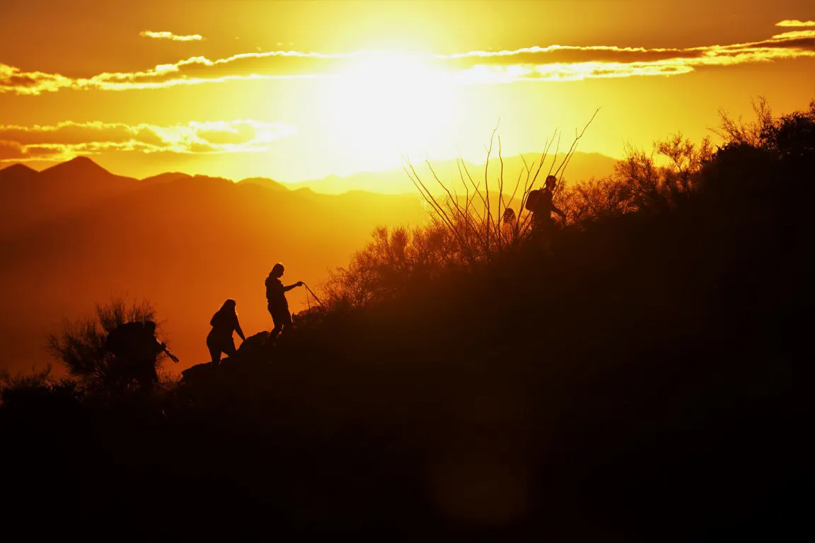 Hiking trail silhouettes photography of people hiking at sunset