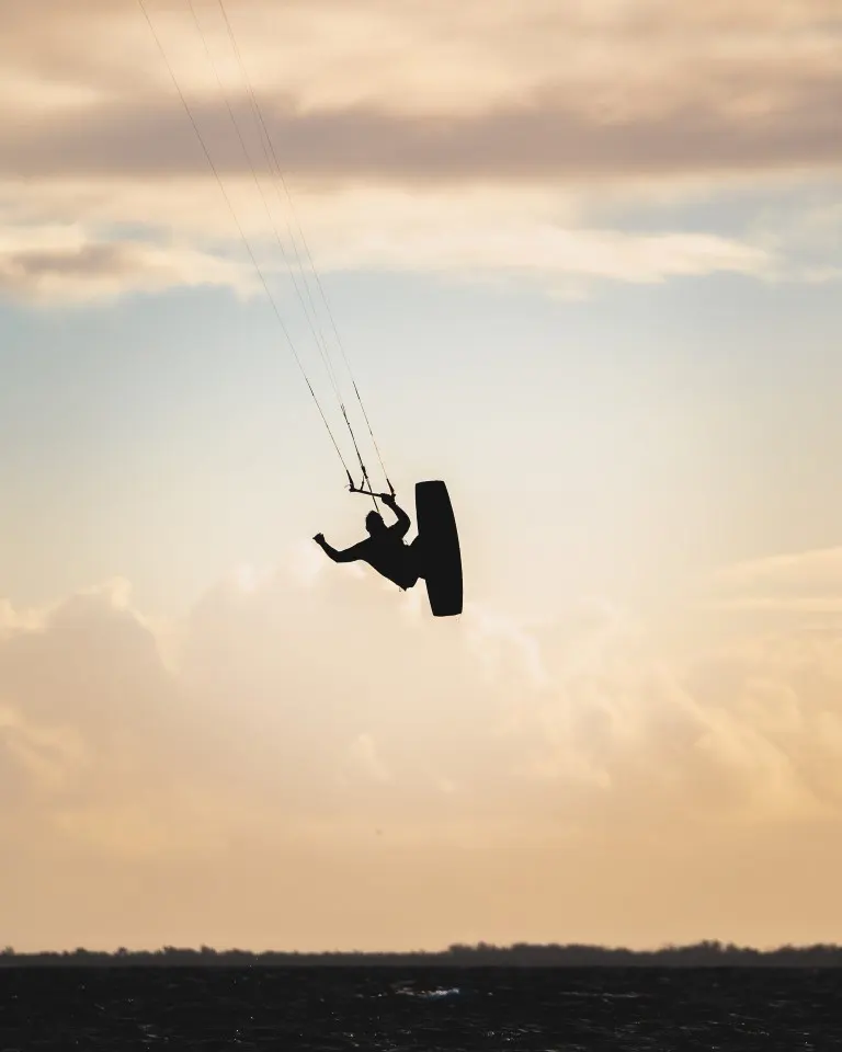 Silhouette of a person kiteboarding