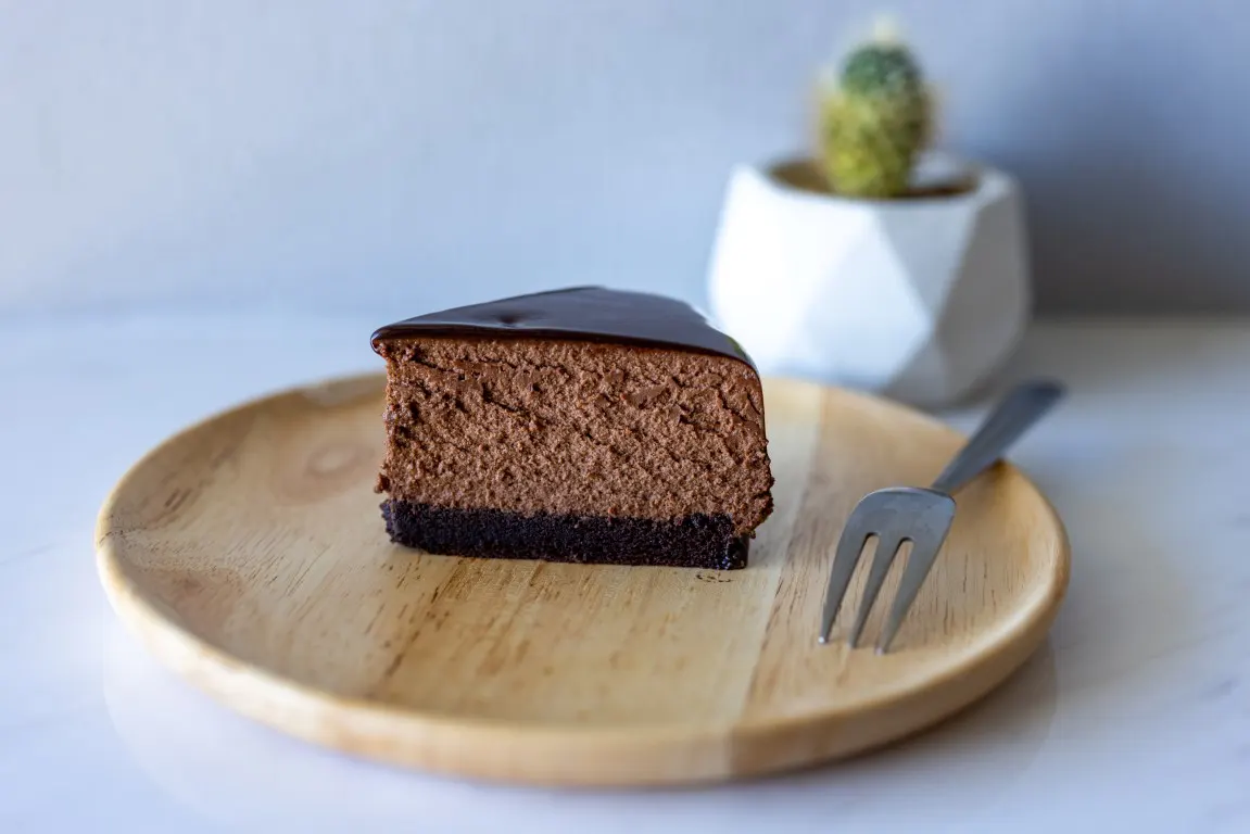 A slice of chocolate cake on a blurred background